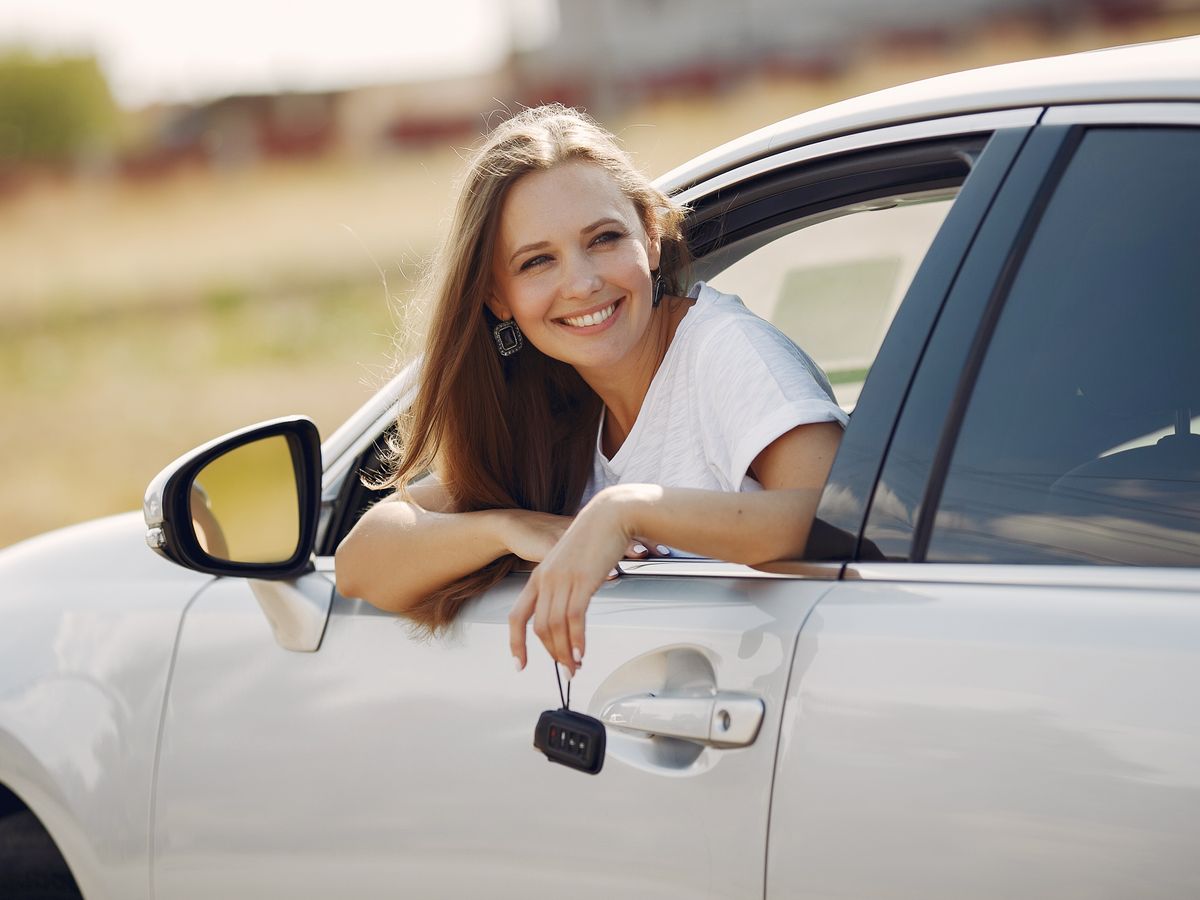 A happy customer holding car keys, representing the confidential car key manufacturer Atrium worked with