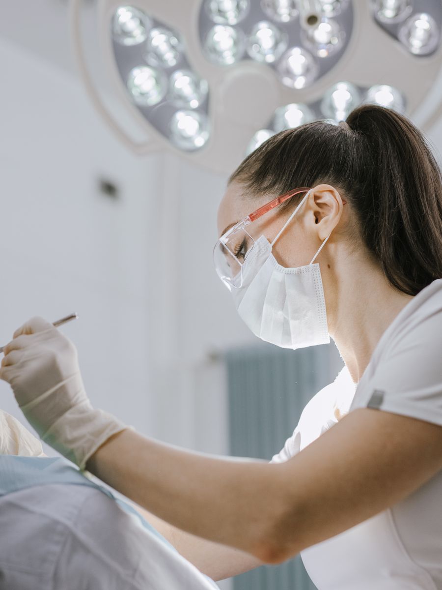 A dental hygienist caring for a patient