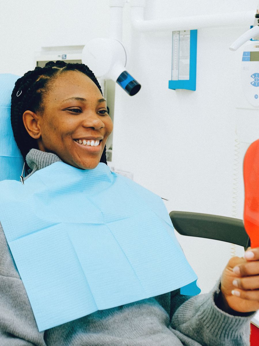 A happy patient smiling in a dental chair