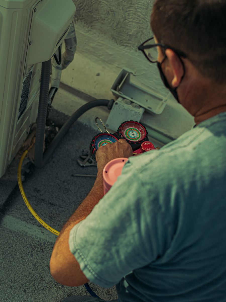 A heating and cooling technician on a home service call