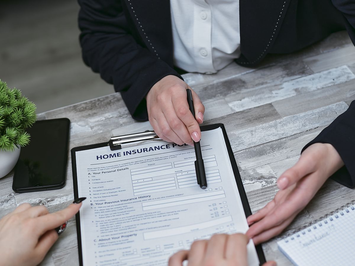 An agent reviewing a policy with a client