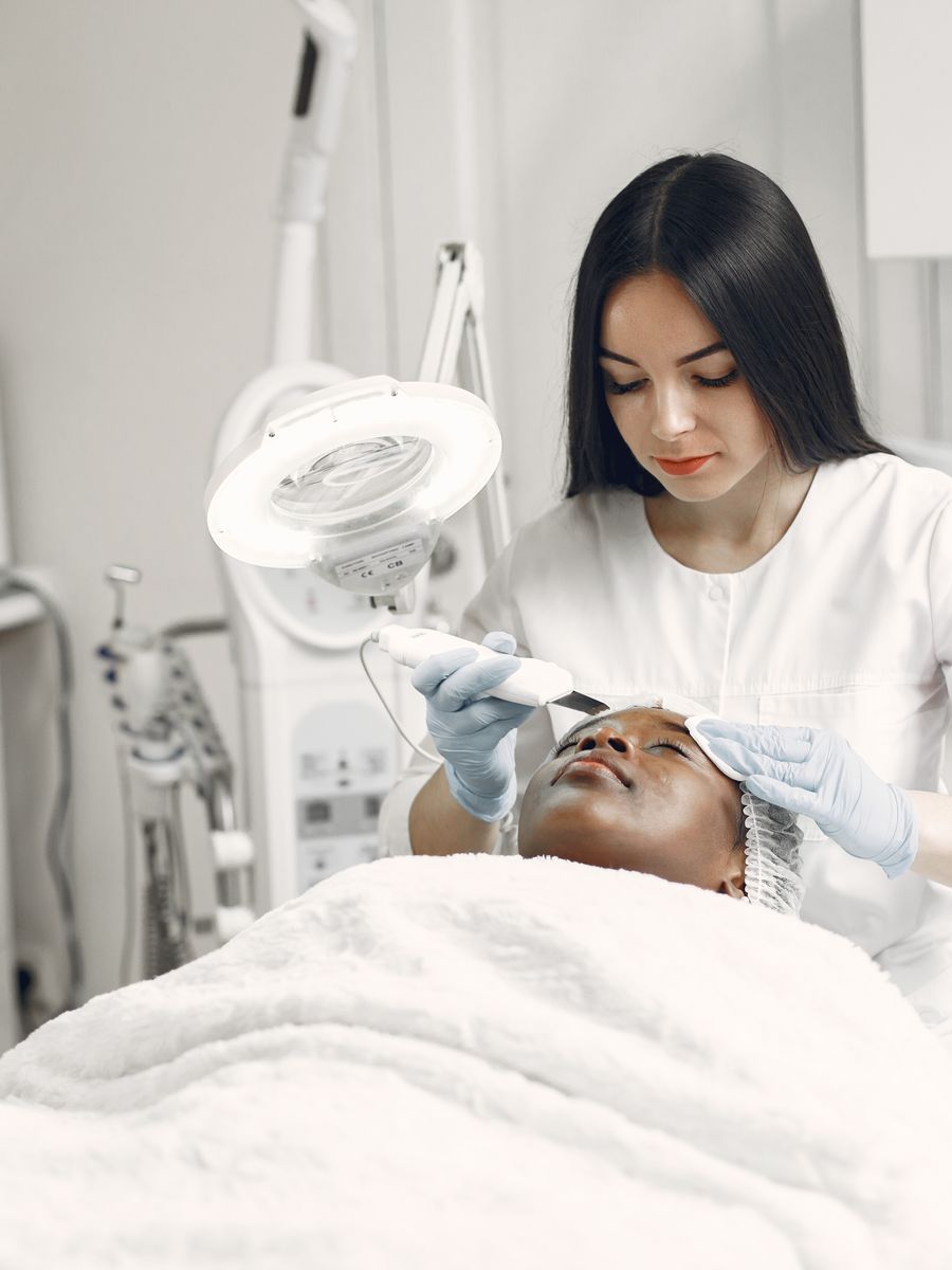 An aesthetician giving a client a facial treatment